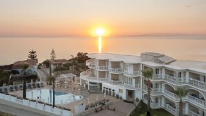 A resort with a pool, multiple balconies, and a sunset view. - Arkadia Hotel (Arkadii)