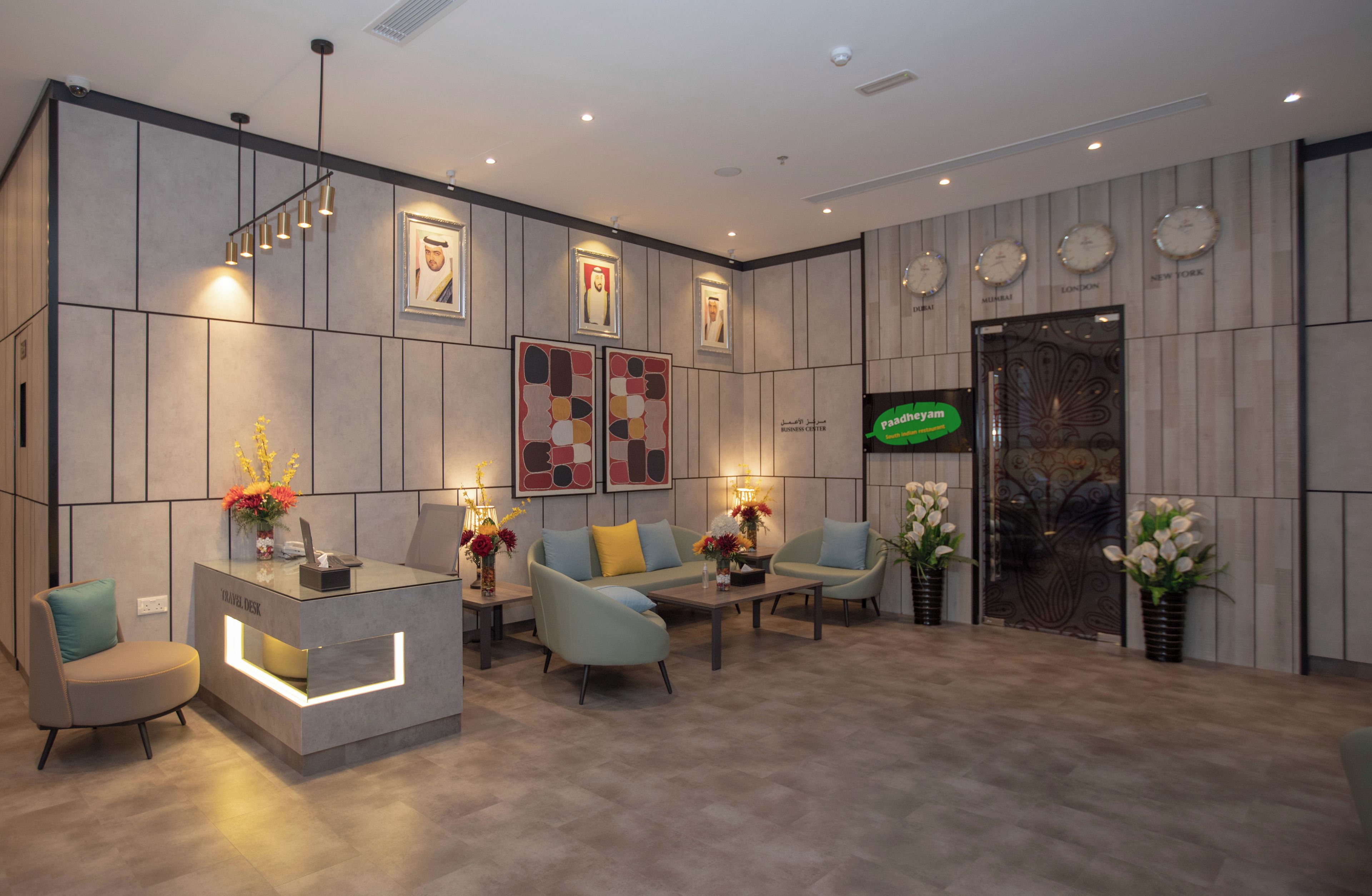 A modern reception area with a travel desk, seating, and decorative elements.