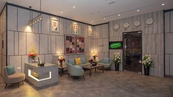 A modern reception area with a travel desk, seating, and decorative elements.