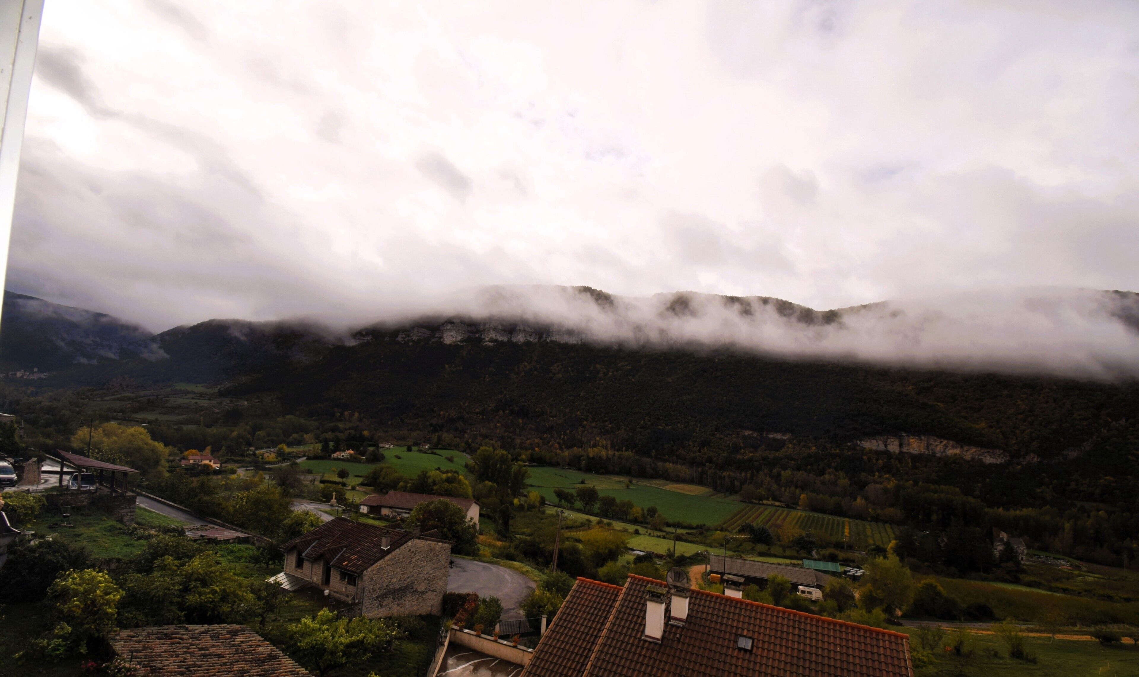 A mountainous landscape with houses and fields.