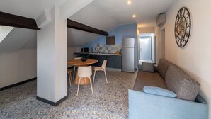 A compact living space with a dining area, kitchenette, and a sofa. - APARTMENT No. 9 ( CIN: IT008031B4324MG4G6 Citra 008031-LT-1495 ) (Imperia)