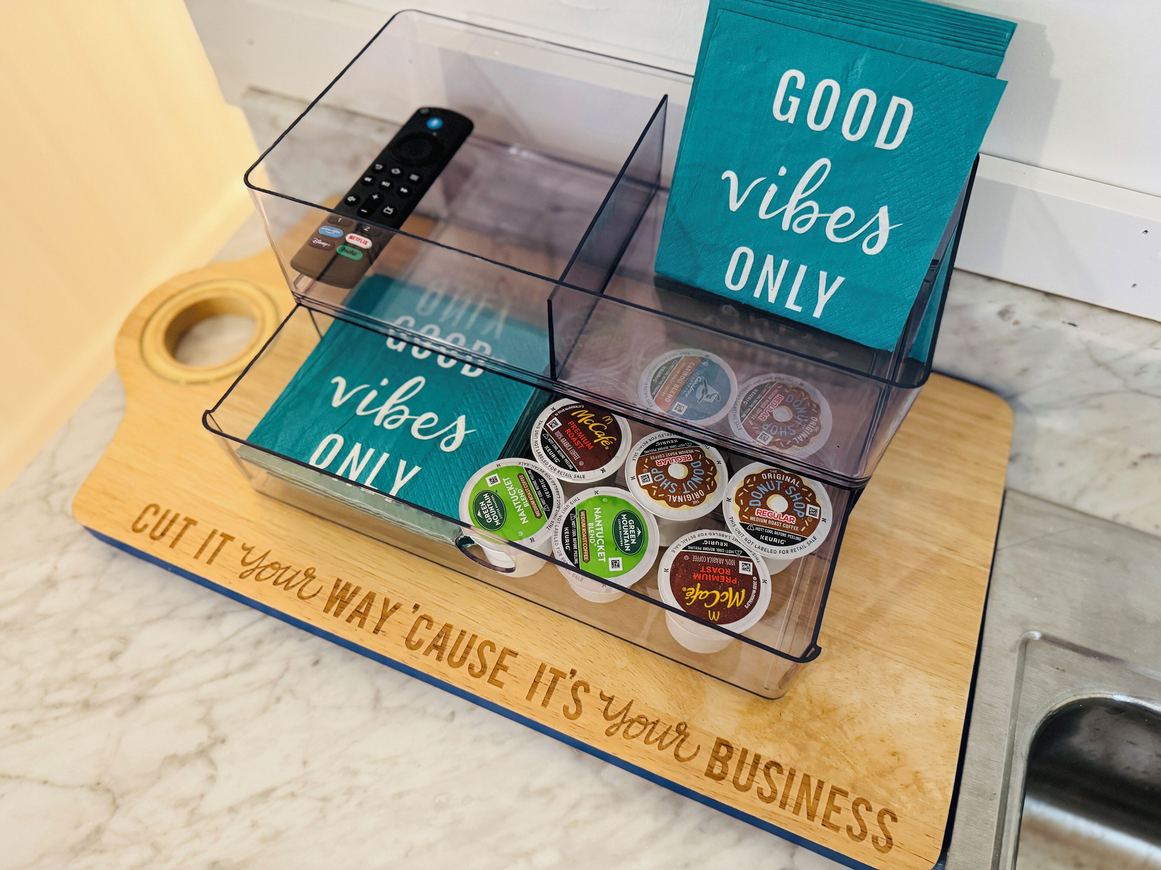 A coffee display with various brands and a sign that says "GOOD vibes ONLY".