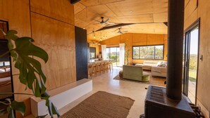 A modern interior with a kitchen, bar area, and seating. - Ocean View Escape - less than 5 min to the highway (Sandy Beach)