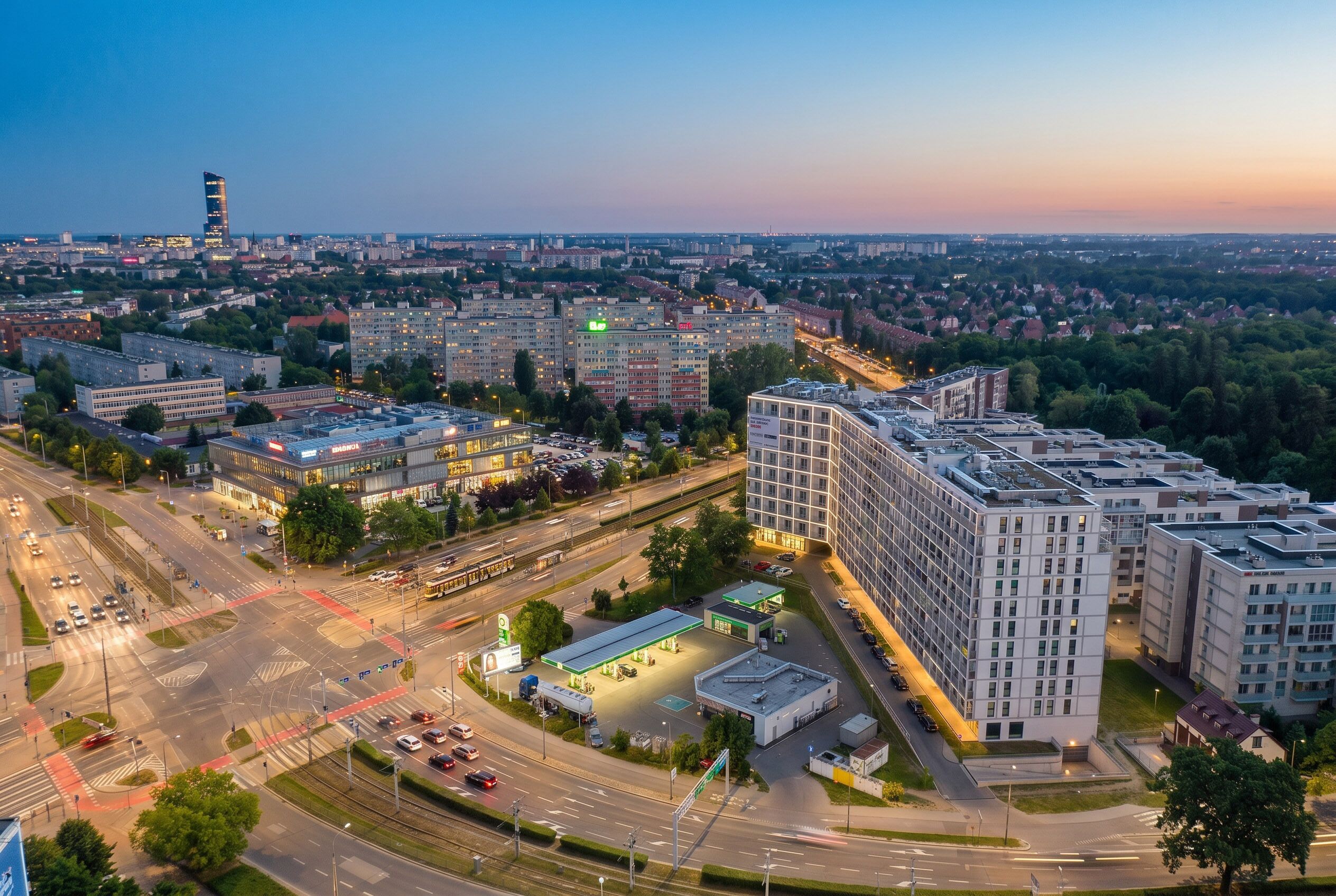A multi-story building with a modern design, surrounded by roads and greenery.