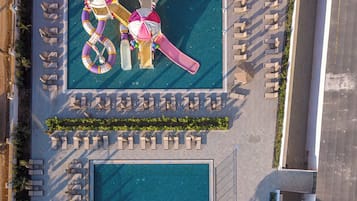 An aerial view of a pool area with multiple water slides and lounge chairs.