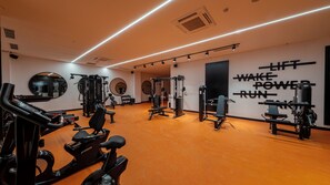 A gym with exercise equipment, mirrors, and motivational wall text. - Raxeria Hotel - All Inclusive (Manavgat)