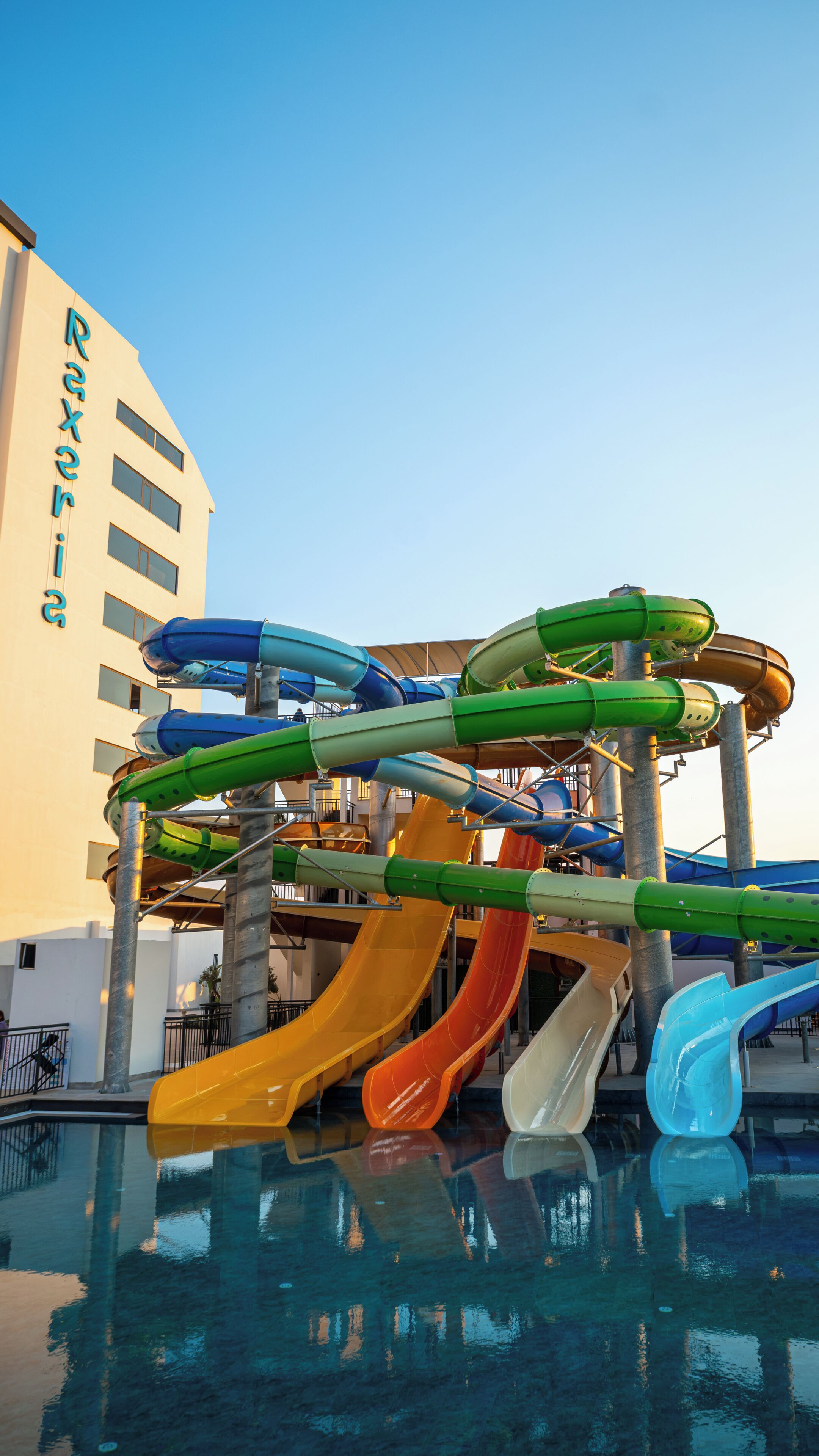 A water park with multiple slides and a pool.