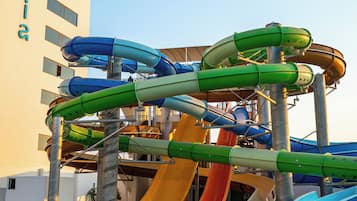 A water park with multiple slides and a pool.