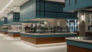 A modern kitchen with stainless steel appliances, teal cabinetry, and a clean, spacious layout.