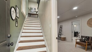 A staircase with wooden steps leading to a landing. - Gothic Garden Bright, Cozy Escape with Modern Touches in Historic Bryan (Bryan)