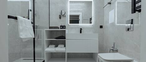 A modern bathroom with a glass shower enclosure, a white vanity with a mirror, and a toilet.