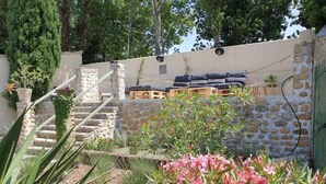 A stone staircase leading to a wooden deck with outdoor seating. - Le Mas des Poules chambres  (Saint-Roman-de-Malegarde)