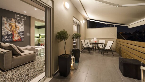 Un espace de vie moderne comprenant un canapé, une table à manger avec des chaises et une plante en pot.