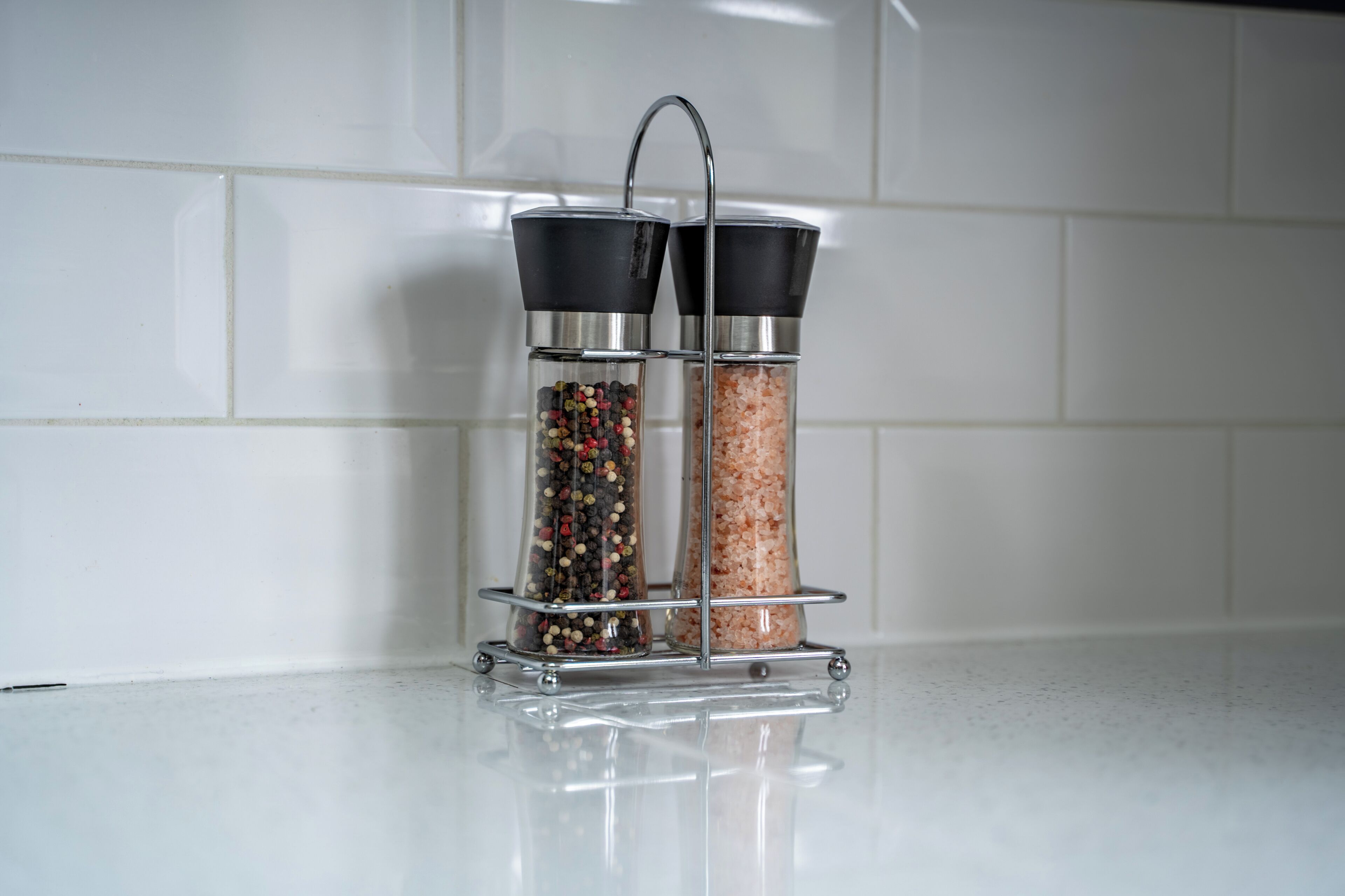 Two salt and pepper shakers on a kitchen counter.