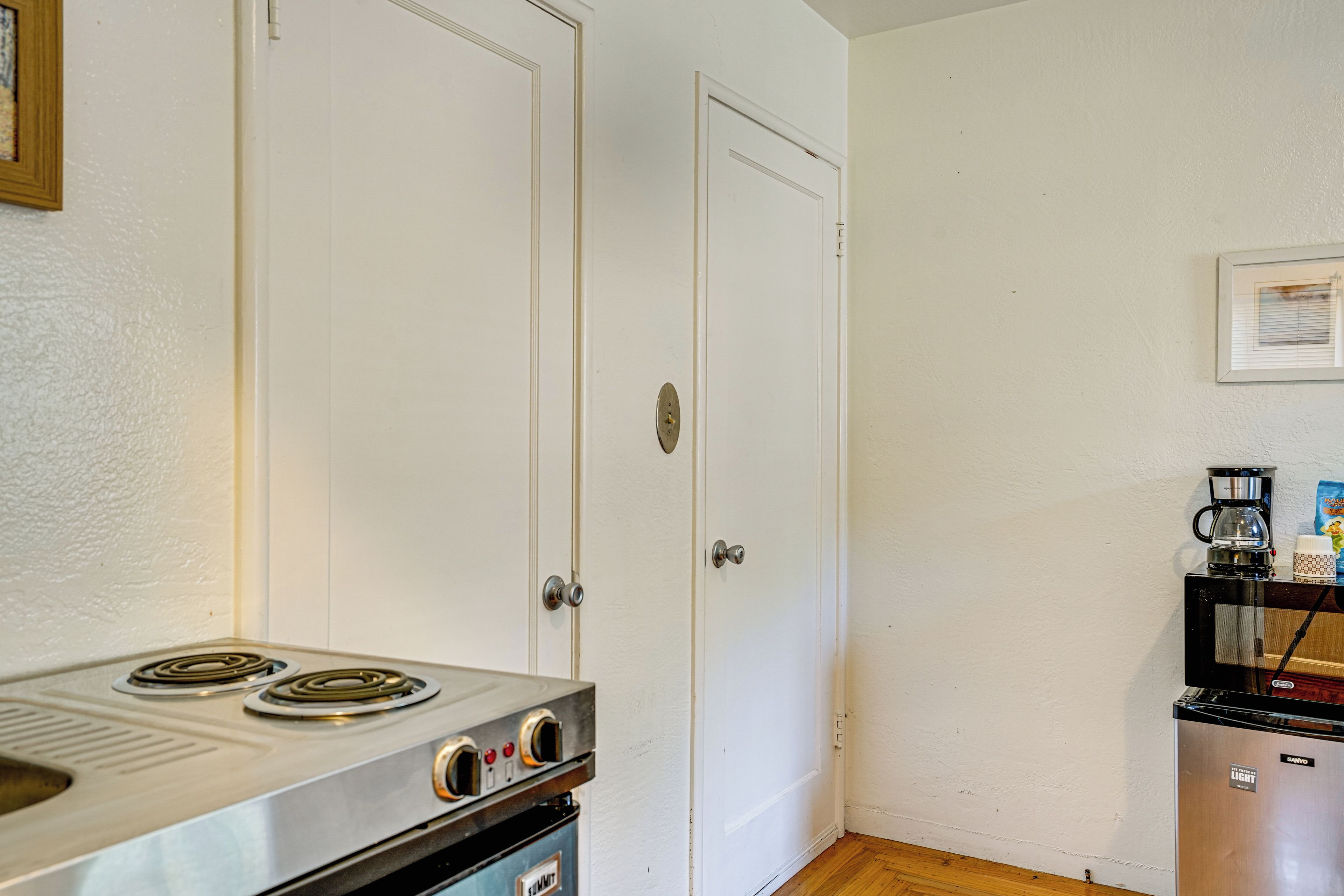 A compact kitchen with a stove, oven, and refrigerator.