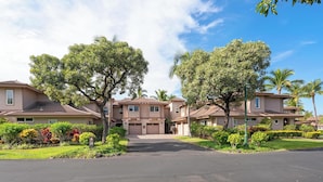 A residential area with multiple two-story houses, each with a garage, surrounded by well-maintained lawns and trees. - Summer Deal Waikoloa Townhome with Resort Pools Hot Tub and A-Bay (Waikoloa)