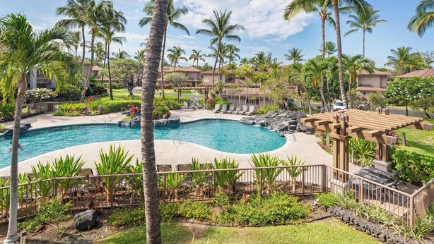 A pool area with palm trees, lounge chairs, and a wooden pergola. - Summer Deal Waikoloa Townhome with Resort Pools Hot Tub and A-Bay (Waikoloa)
