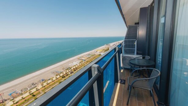A balcony with a view of the beach and ocean. - Holiday in orbi city  (Batumi)