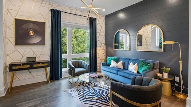 A modern living room with a blue sofa, a round coffee table, and a zebra-pattern rug. - Upscale & Cool - Walk to Bars - Mins. to Broadway (Nashville)