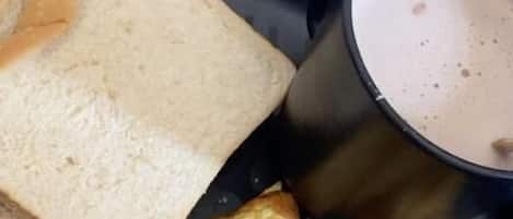 A plate with toast, a slice of omelette, and a cup of coffee.