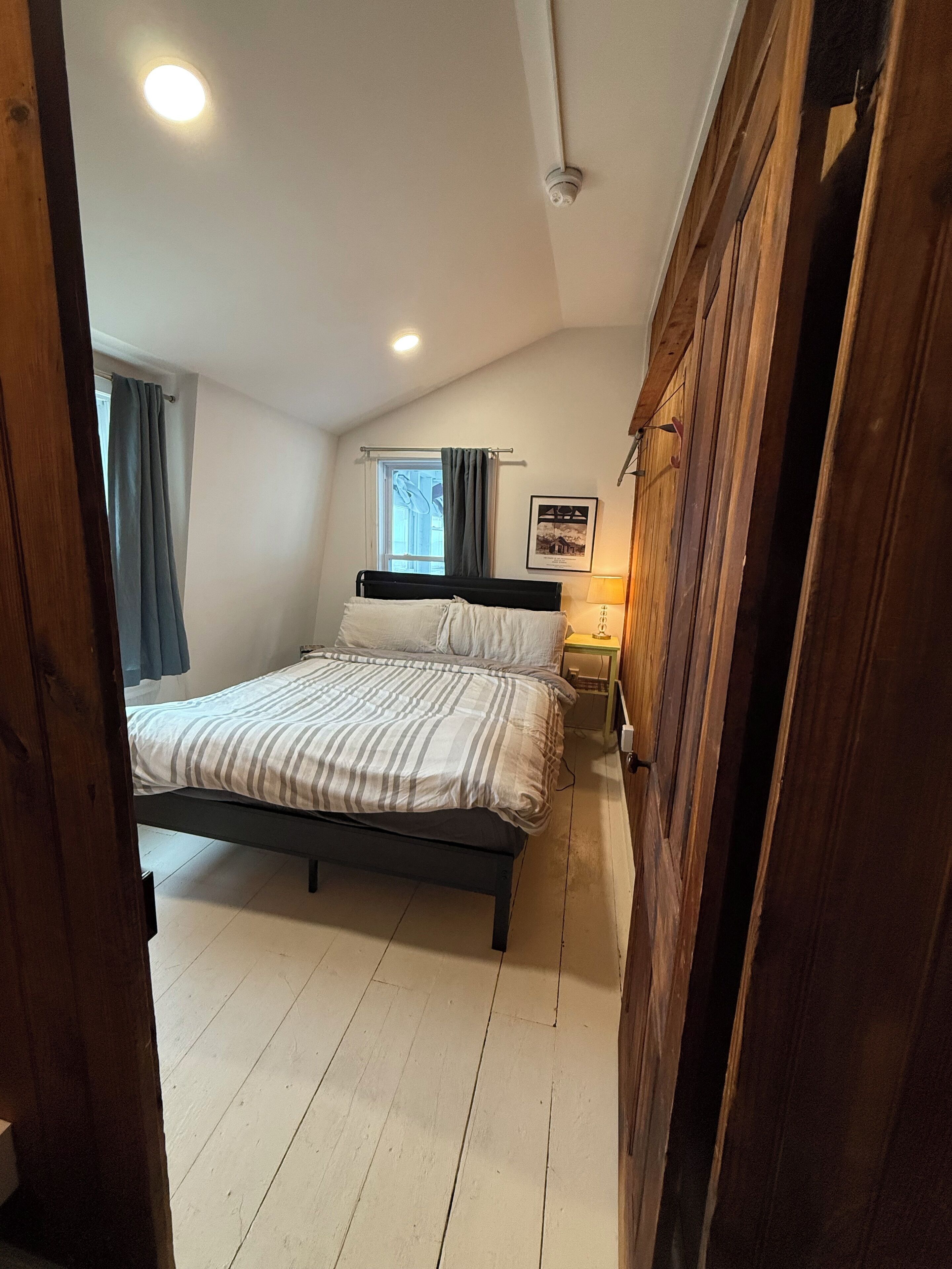 Queen bed in upstairs bedroom on left.