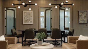 A conference room with a long table, six chairs, and a potted plant. - Landing | Stylish 1BD, Clubhouse, Gym (Oakwood)
