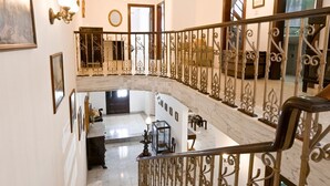 A grand staircase with ornate metal railings leading to a second-floor balcony. - 7 MEDITERRANEA VILLA (St. Paul's Bay)
