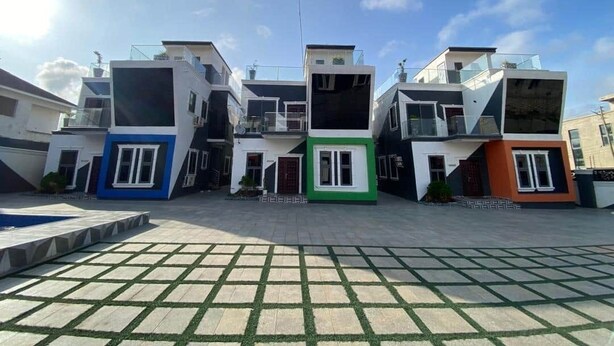 A modern residential complex with multiple two-story houses, a central courtyard, and a swimming pool. - ftrealtyproperties (Accra)
