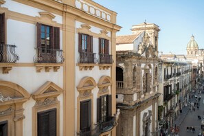 A street view of historic buildings with ornate balconies and classical architecture. - Palazzo Balsamo  (Palermo)