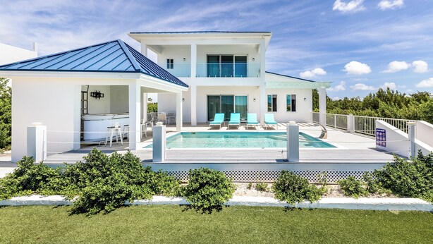 A modern two-story house with a swimming pool, outdoor seating, and a well-maintained lawn. - New Unique Villa Blue Top! 2 Bedrooms Waterfront with Kayak (Bay, Cooper Jack)