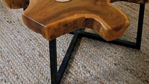 A wooden coffee table with books and a decorative sculpture. - Charming 3-bedroom Ranch in Weston Near Westport & Fairfield (Weston)