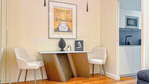 A modern kitchen with a microwave, sink, and a framed poster on the wall. - Foro Exclusive Suite - 5 mins from Duomo (Milano)