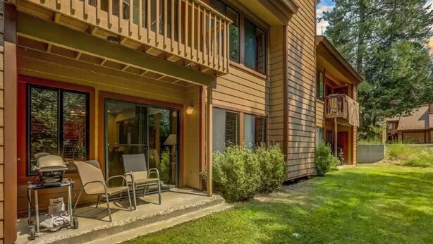 A two-story house with a covered porch, a grill, and outdoor seating. - Convenient Townhome Near Downtown McCall (McCall)
