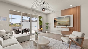 A modern living room with a large TV, comfortable seating, and a view of the outdoors. - Upstay-luxury 3BR Home w Private Pool Games Room (Clermont)
