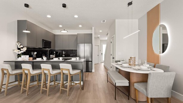 A modern kitchen with a central island, bar seating, and a dining area with a round table and chairs. - Upstay-luxury 3BR Home w Private Pool Games Room (Clermont)