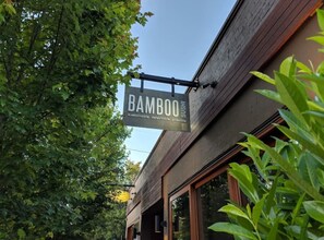 A building with a sign that reads 'Bamboo' and the words 'sustainable, recyclable, possible.'