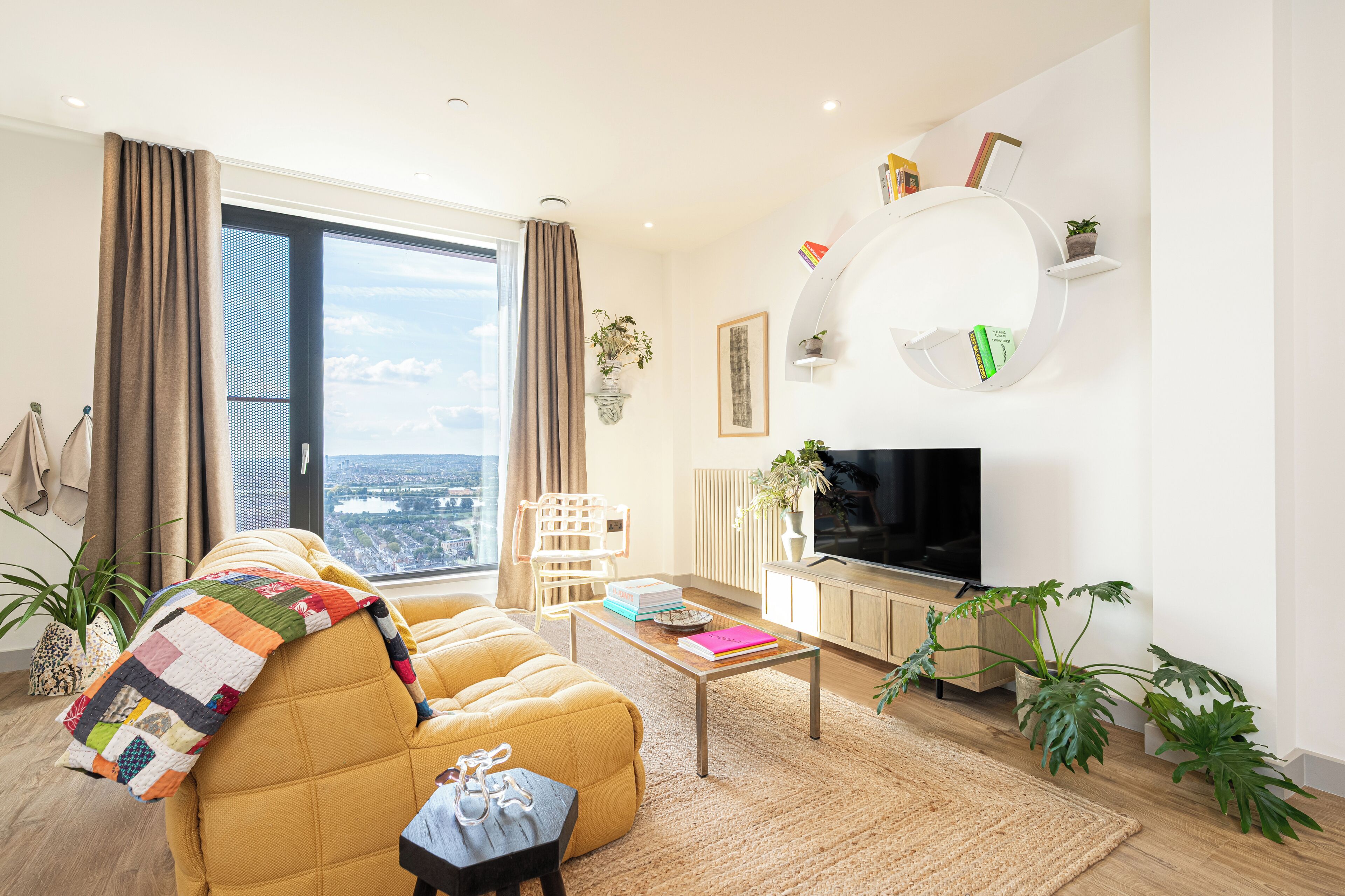 A modern living room with a sofa, coffee table, and TV.