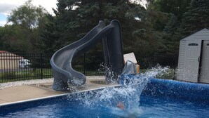 A swimming pool with a slide. - Peaceful country 5 bedroom home. Come make memories at your home away from home. (Poynette)