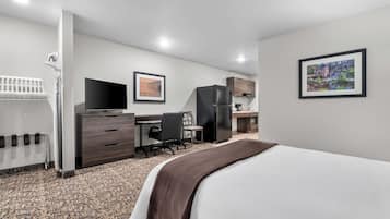Desk, laptop workspace, blackout drapes, iron/ironing board