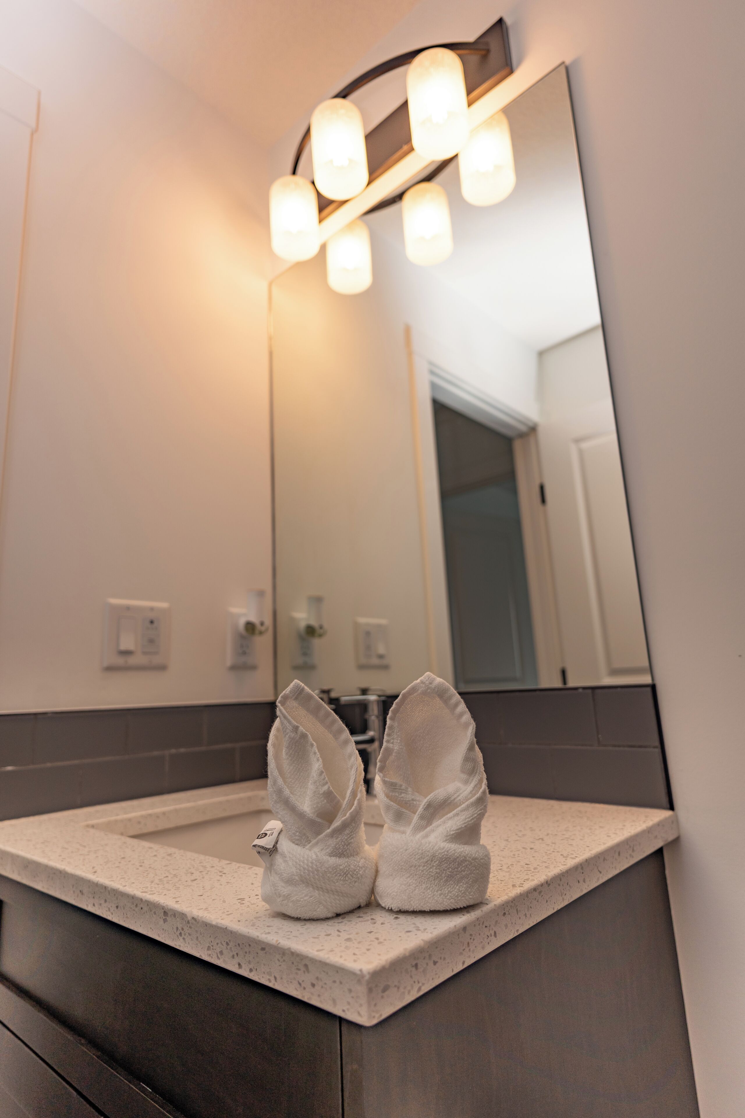 A bathroom with a mirror, a towel rack, and a sink.