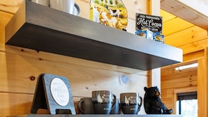A coffee station with a Keurig coffee maker, two mugs, and a sign for 'Our Little Coffee Bar'. - Modern Rustic Log Cabin-Dog Friendly-Fenced-Views-Hot Tub (Morganton)