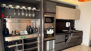 A modern kitchen with stainless steel appliances, a pull-out pantry, and a hanging wine rack. - White Lotus 10 of 10 (St. Paul's Bay)