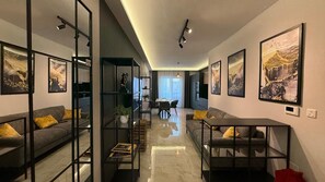 A modern living room with a sofa, coffee table, and artwork on the walls. - White Lotus 10 of 10 (St. Paul's Bay)