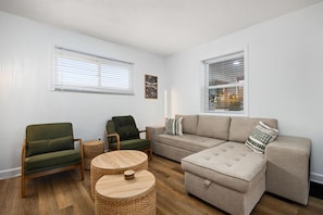 A living room with a sofa, two armchairs, a coffee table, and a small side table. - Family Retreat, Walk to Prospect Rd at Heights Haus (Peoria Heights)