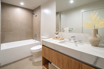 Deluxe Two Bedroom King Suite | Bathroom | Free toiletries, hair dryer, bathrobes, slippers at The Crosby Miami Worldcenter