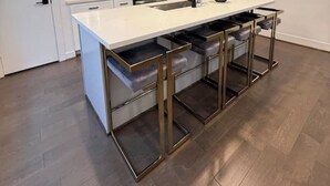 A modern kitchen with a white countertop, stainless steel appliances, and a bar stool area. - Cozy & Luxury 3BR for Families, Nurses & Groups (Houston)
