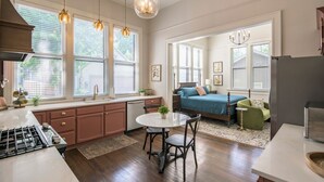 A kitchen with a dining area, a bed, and a living room. - The Estuary Indy - Your Private Sanctuary! (Indianapolis)
