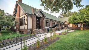 A traditional building with a brick facade, large windows, and a green roof. - The Estuary Indy - Your Private Sanctuary! (Indianapolis)