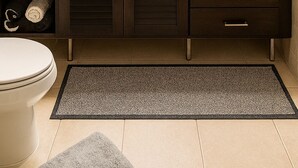 Un baño moderno con dos lavamanos, un espejo grande y un mueble tocador de madera oscura con cajones.