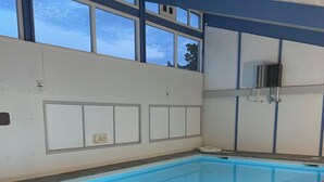 A swimming pool with clear blue water, surrounded by a tiled deck. - Holiday bliss by forest and Bornholm’s top beach (Nexø)